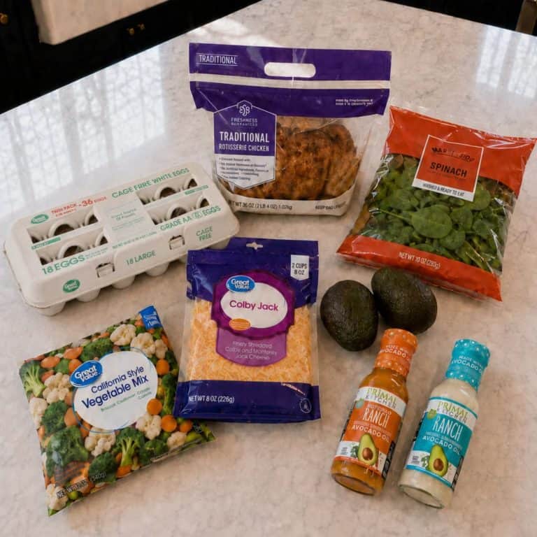 Lazy keto dinner grocery staples including rotisserie chicken, eggs, spinach, frozen vegetables, cheese, avocados, and ranch dressing